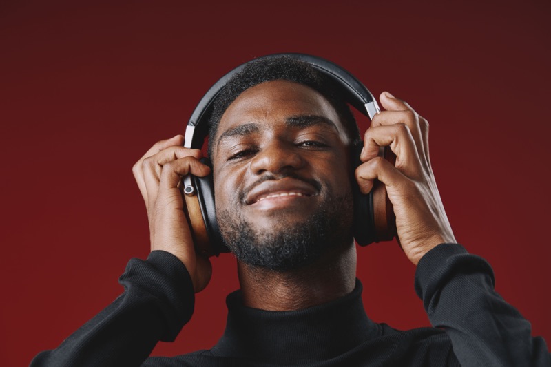 Man in headphones against a red background