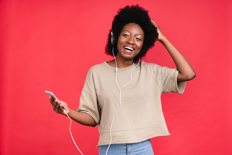 Woman listening through headphones