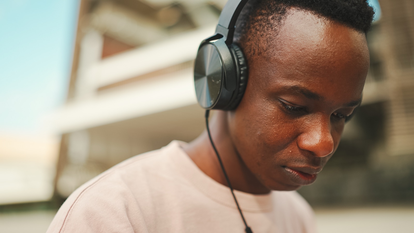 A student listening outdoors